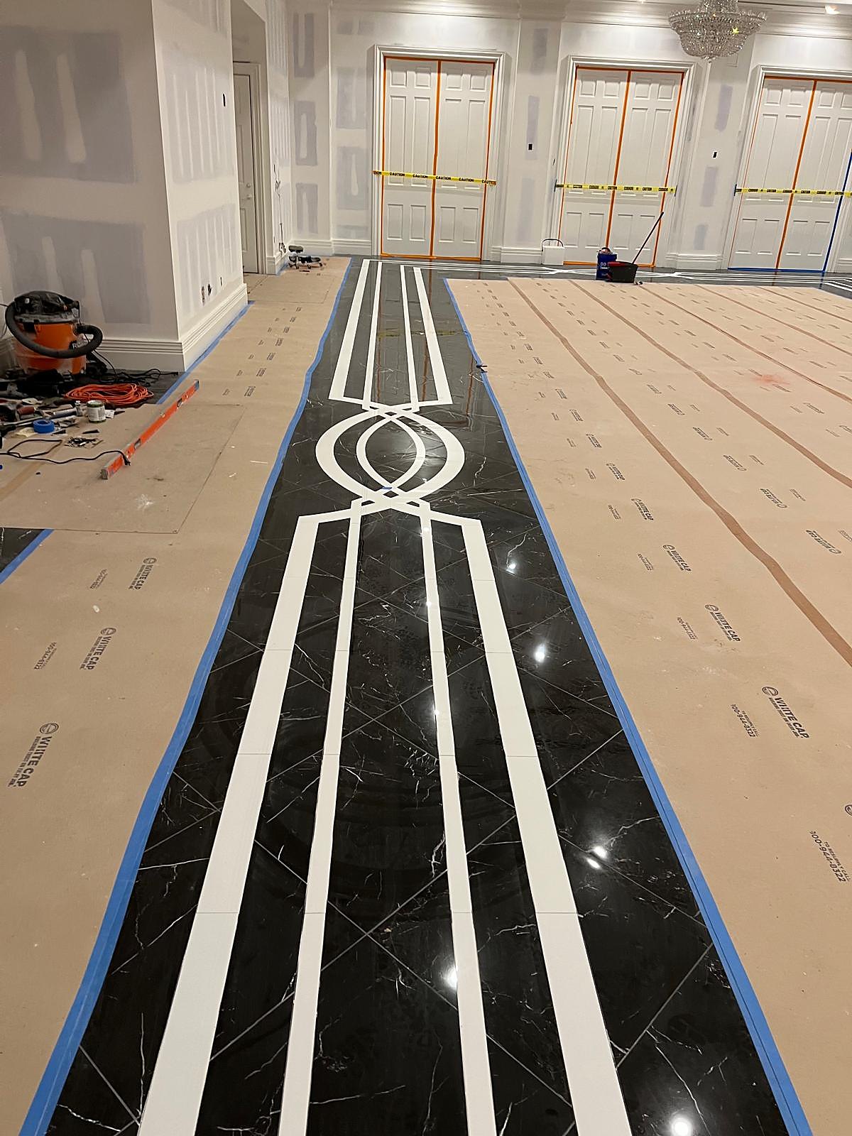 Hotel corridor with marble floor and white border inlay