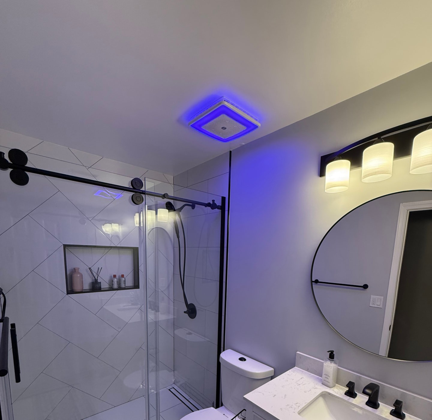 Modern bathroom with large-format tile walk-in shower, matte black hardware and tiled niche